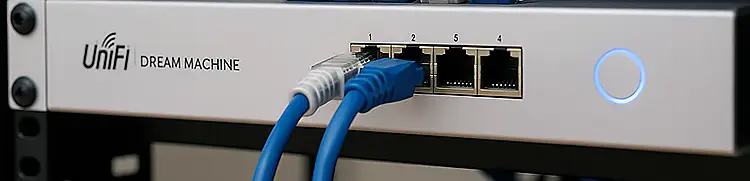 UniFi switch ports with Ethernet cables connected and status LEDs active